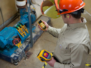 Technician reviewing measurements from Fluke Connect? tools on smartphone